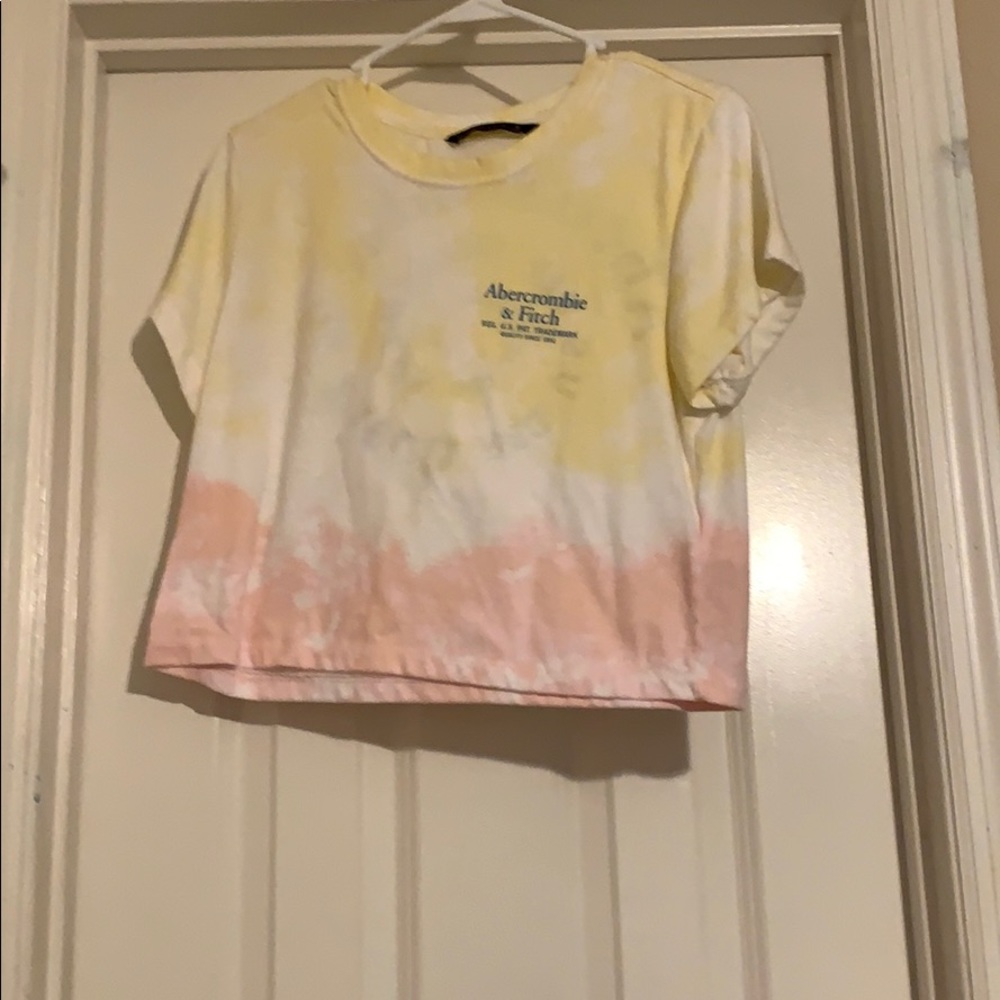 A yellow white and pink crop top